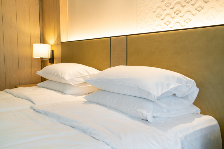 white pillow decoration on bed